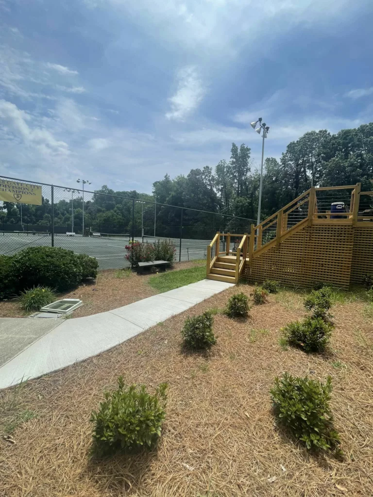 Concrete sidewalk and landscaped planting beds at a commercial property