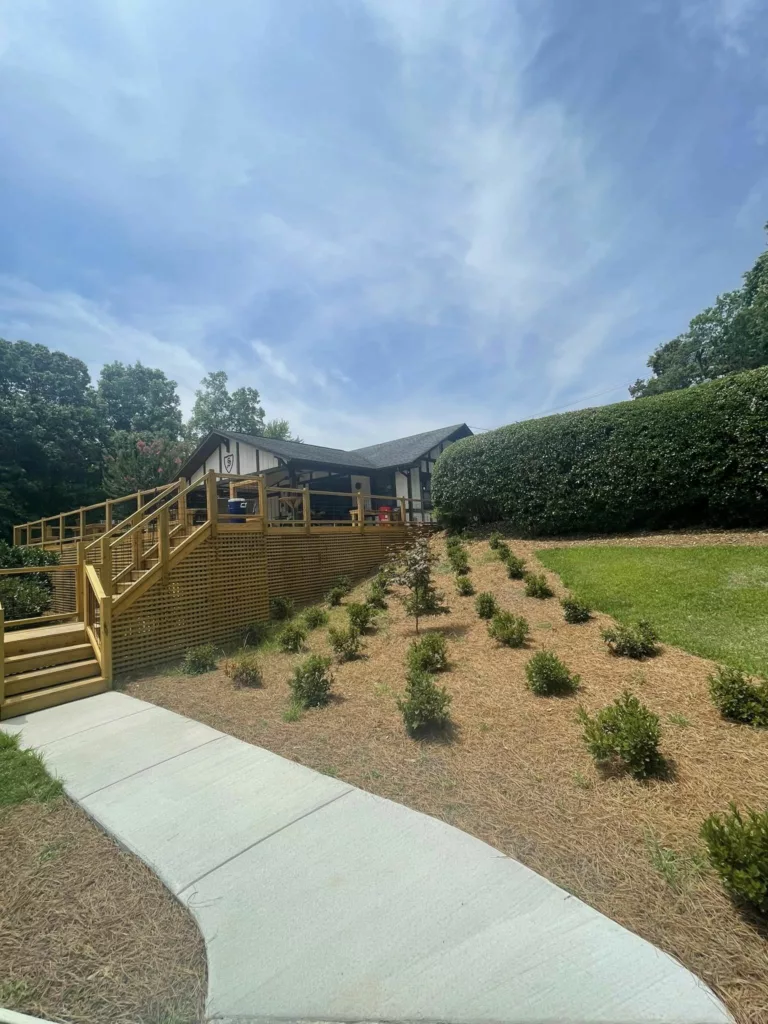 New concrete sidewalk through a landscaped commercial property