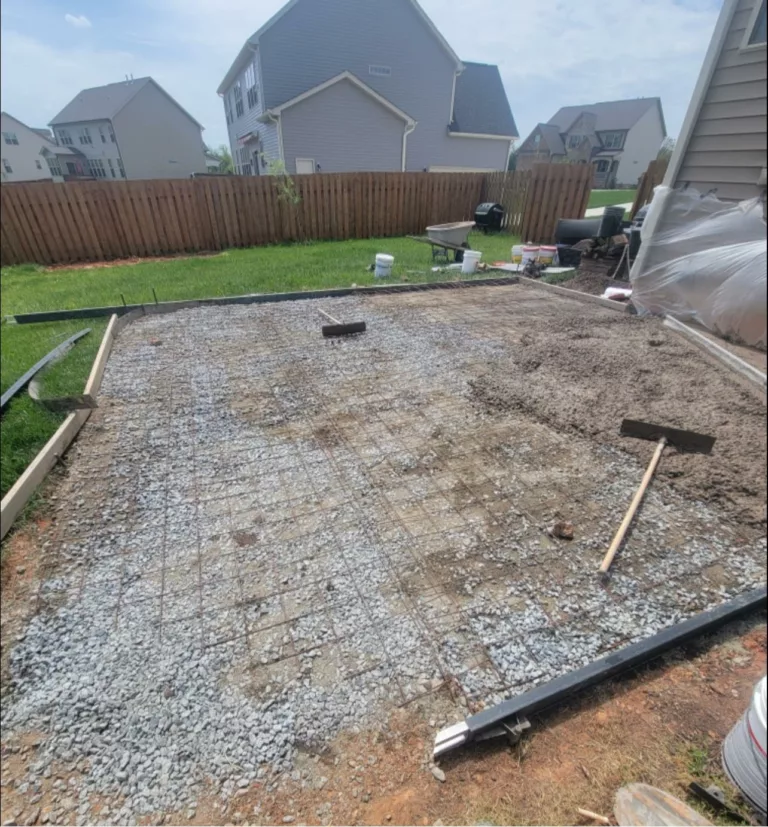 Prepared gravel base for a new backyard concrete patio