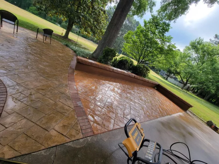 Sealed brown stamped concrete patio beneath mature trees