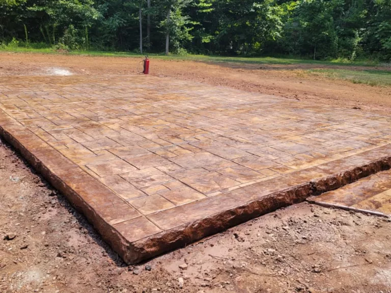 New rectangular stamped concrete patio with a warm stone pattern
