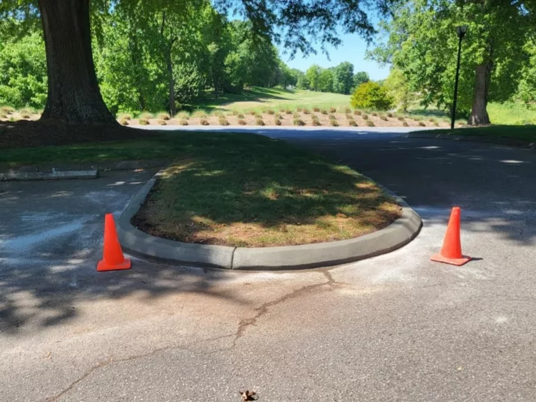 New concrete curb around a landscaped parking lot island