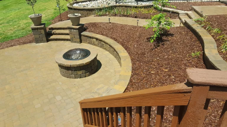 Overhead view of a circular patio and fire pit with landscaping