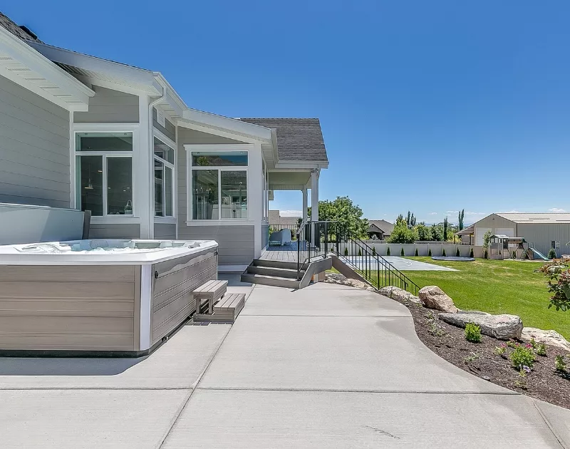 Backyard patio with hot tub and garden.