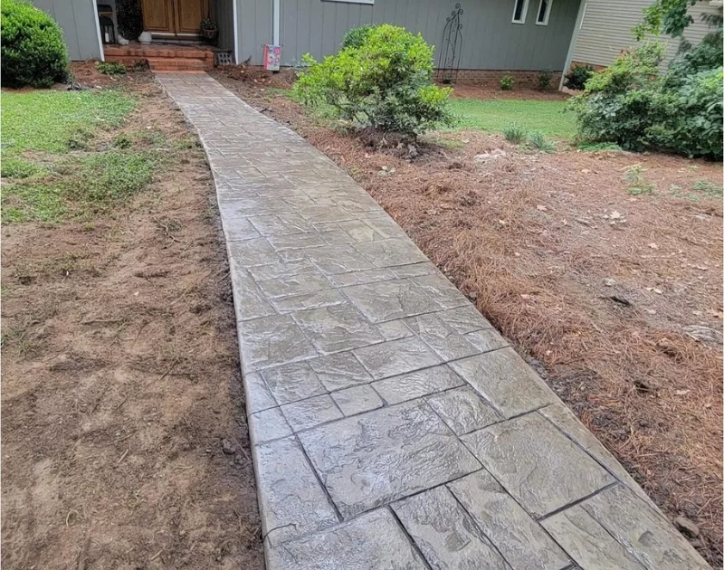 Concrete walkway leading to a house entrance